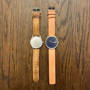 Pair of MVMT and Skagen watches.
